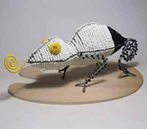 Bead and Wire Sculpture of a Chameleon: White body with black tail, yellow beaded eyes and tongue. Handcrafted masterpiece.