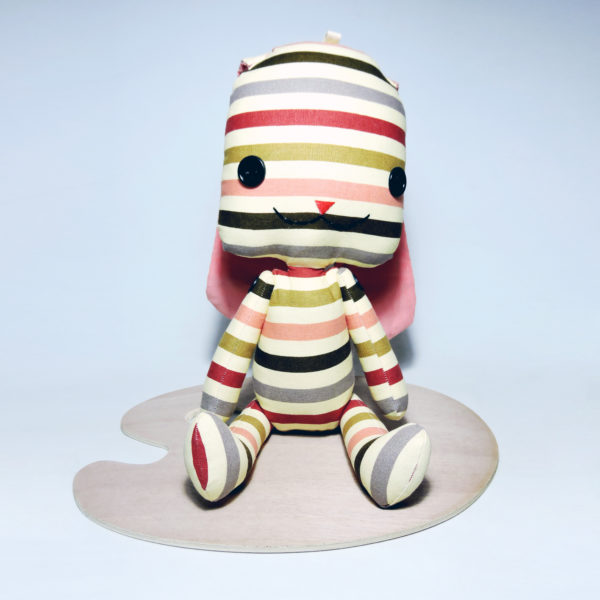 image of a Striped Rabbit Plush Toy with colorful stripe patterns on soft beige fabric. Size: 57cm x 13cm.