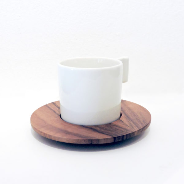 A ceramic teacup with a wooden saucer, perfect for serving your favorite hot beverages in style.